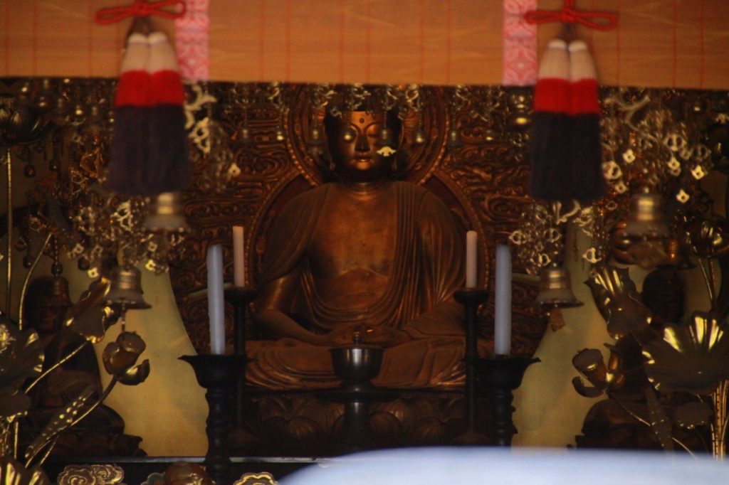 Buddha sitting inside of a temple 